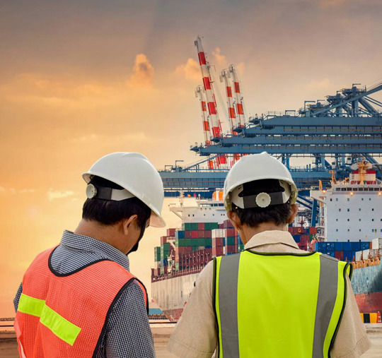 Marine operations specialists at a working cargo terminal